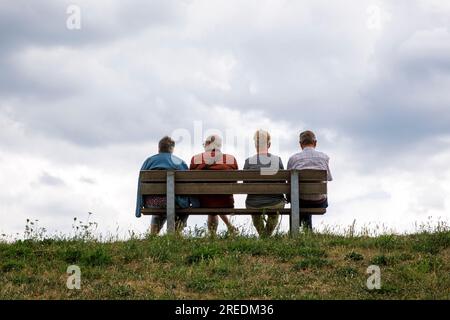 seniors sitting on a bench on the dike in Zons on the river Rhine, North Rhine-Westphalia, Germany Senioren sitzen auf einer Bank auf dem Deich in Zon Stock Photo