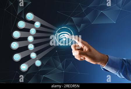 Businessman using virtual screen with digital wifi icon on dark blue background Stock Photo