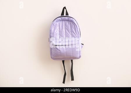 Lilac school backpack on light background Stock Photo