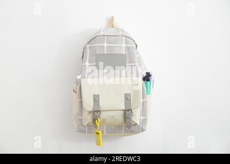 Grey school backpack with stationery on white background Stock Photo