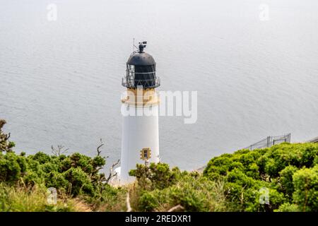 Maughold Head lighthouse stands on the Isle of Man's most Easterly point, protecting shipping since 1914. Updated to LED from paraffin lamp in 1993 Stock Photo