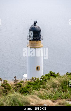 Maughold Head lighthouse stands on the Isle of Man's most Easterly point, protecting shipping since 1914. Updated to LED from paraffin lamp in 1993 Stock Photo