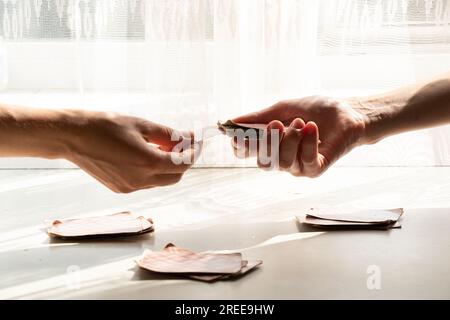 Playing cards at the table near the window at home, gambling board games, hobby Stock Photo