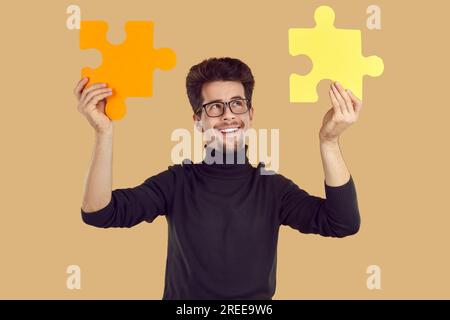 Portrait handsome smiling funny young guy in transparent glasses. Stock Photo