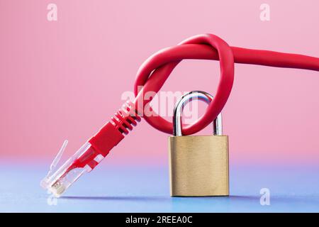 A closed lock on a network wire tied into a knot, a concept on the security of computer networks Stock Photo