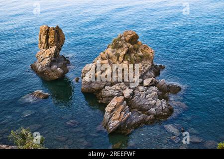 Rocks jutting out of the sea at Spiaggia Caldura beach in Cefalu, Sicily Stock Photo