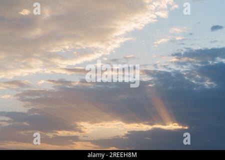 Dramatic cloudy sky with sun rays photographic background Stock Photo