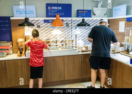 Alpharetta Atlanta Georgia,Holiday Inn Express Alpharetta-Roswell,IHG hotel,lodging inns motels,business,free breakfast self-serve service,father son Stock Photo