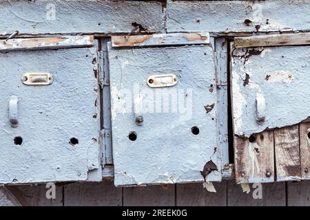 Three very old and grungy mailboxes Stock Photo