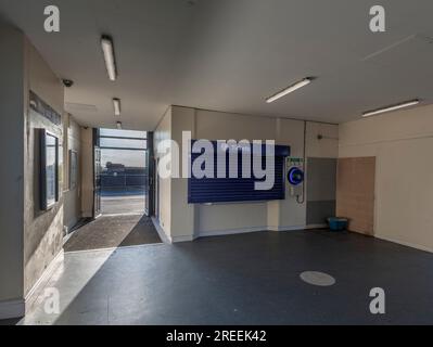 Kirkham And Wesham  Railway station, closed  ticket office with the shutter down and an automated external defibrillator on the wall Stock Photo