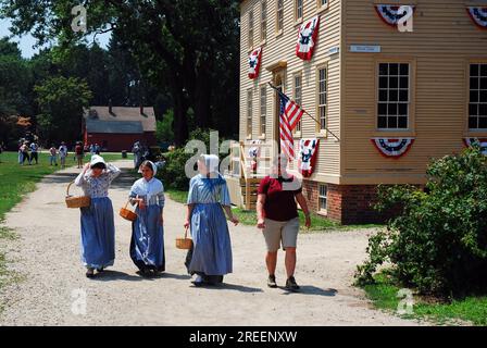 Costumed re-enactors stroll through Strawberry Banke, a recreated historic village in Portsmouth, New Hampshire Stock Photo