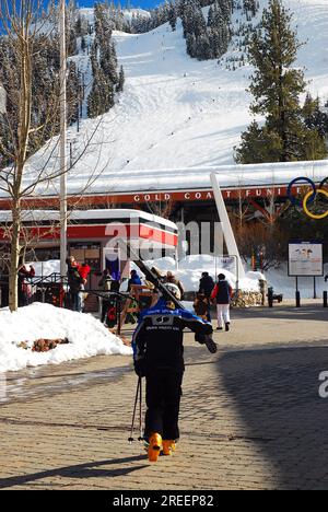 A skier heads towards the lift at at a ski resort in Olympic Valley, formerly Squaw Valley, California Stock Photo