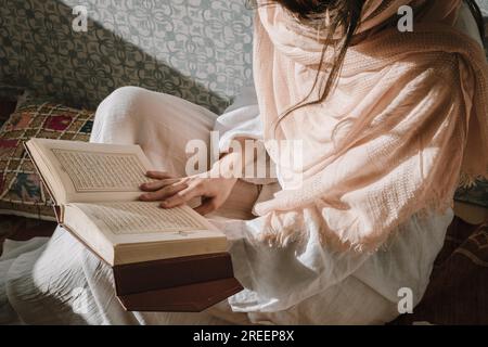 Sitting woman reading quran. Resolution and high quality beautiful photo Stock Photo