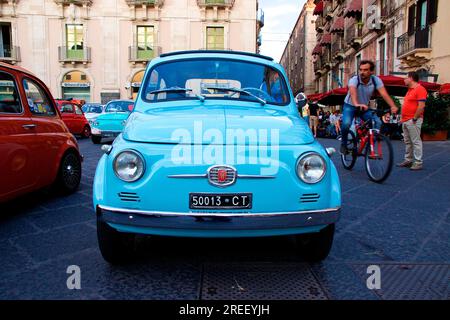 Light blue Fiat 500, Bambini, head-on, cyclist, Catania, Old Town, Baroque Old Town, Eastern Cuisine, Sicily, Italy Stock Photo