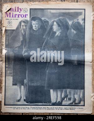Daily Mirror newspaper. Front page news, announces the death of King George VI, who died 6th February 1952. The cover photograph is of three Queens. (l-r) “A sorrowing family group of three Queens - Elizabeth the Second, Queen Mary, and the Queen Mother - stand at the entrance to Westminster Hall as the Kings coffin is carried past them to the Lying-in-State. On the right is Princess Margaret.” Dated Tuesday February 12th 1952. An old worn used copy of a British tabloid newspaper. 1950s Britain UK. Stock Photo