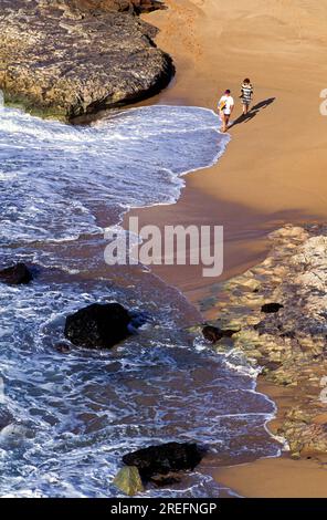 A couple walks along the sand at Kepuhi Beach on Molokai. Stock Photo