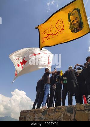 Shia muslims unfurling flags during muharram Procession Stock Photo