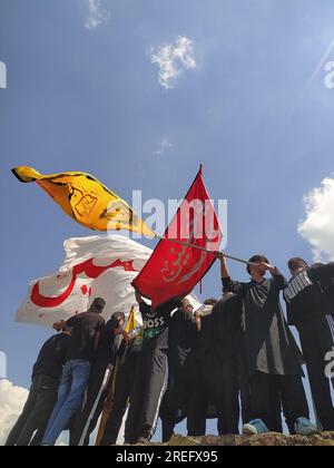 Shia muslims unfurling flags during muharram Procession Stock Photo