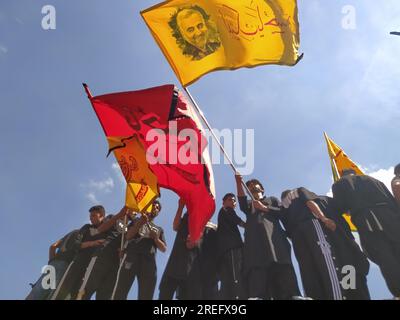 Shia muslims unfurling flags during muharram Procession Stock Photo