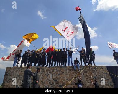 Shia muslims unfurling flags during muharram Procession Stock Photo
