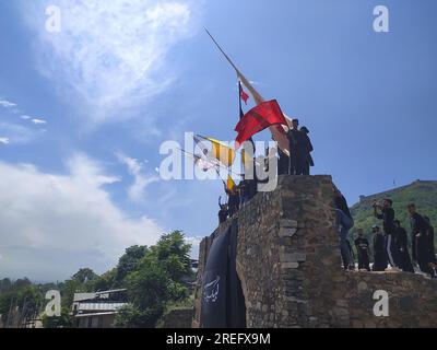 Shia muslims unfurling flags during muharram Procession Stock Photo