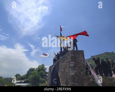 Shia muslims unfurling flags during muharram Procession Stock Photo