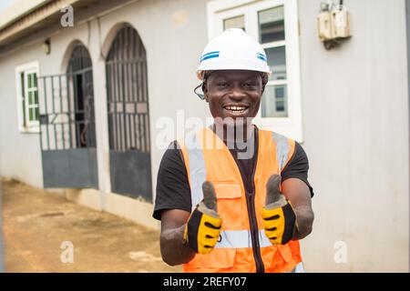 excited young african engineer doing thumbs up gesture Stock Photo