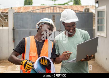 two african engineers working using a laptop Stock Photo