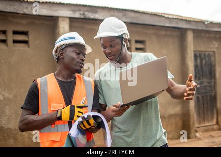 two african engineers working with a laptop Stock Photo