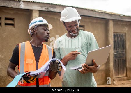 two african engineers working using a laptop Stock Photo