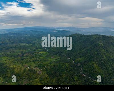 Mountain with jungle and agricultural land. Blue sky and clouds. Mindanao, Philippines. Stock Photo