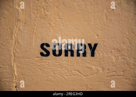Sorry graffiti sprayed using stencil on plaster wall Stock Photo