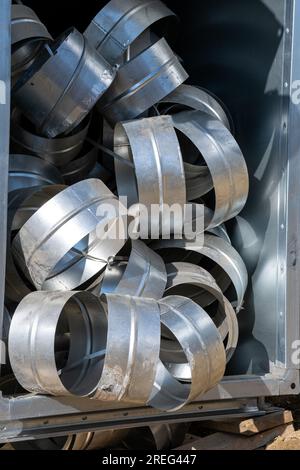 Connecting pipes for air ducts in the box. Various sheet metal air ducts in stock for installation in a building under construction. Ventilation syste Stock Photo