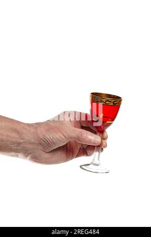 Men's hand holding empty shot glass isolated on a white background. Concept of alcohol, drink, party, degustation, holiday Stock Photo