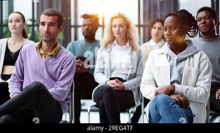 Different groups of people communicate with each other during business seminar or training. Stock Photo