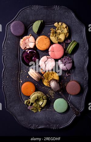 Macarons on a stylish vintage black plate viewed from above Stock Photo