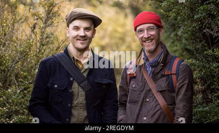 Portrait of two men smiling in nature Stock Photo