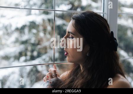 Girl posing near a large beautiful window Stock Photo