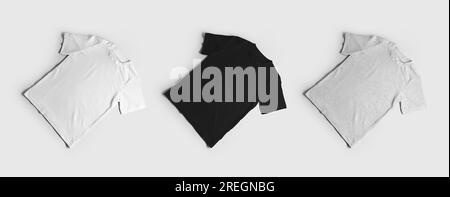 Mockup white, black, heather t-shirts, diagonal presentation, kid's clothes, front. A set of children's cotton shirts isolated on a background. Fashio Stock Photo