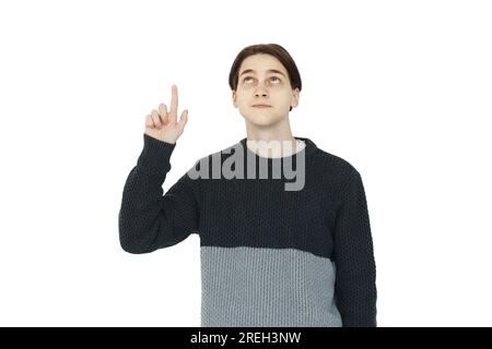 Clever young man in black sweater pointing up on white background Stock Photo