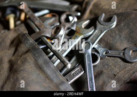 Rusty iron carob keys on a table in the garage Stock Photo
