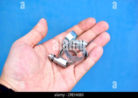 Iron clamps with thread in the hands of the master Stock Photo