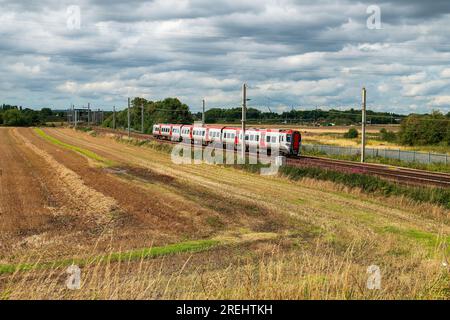 Transport for Wales Class 197 diesel commuter train passing through countryside. Stock Photo