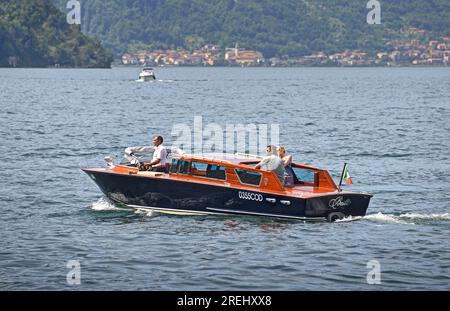 Lake Como, Italy - May 24, 2017: Water taxi ferries tourists on Italian Lake Como between lakeshore towns such as Varenna, Bellagio and Lecco. Stock Photo