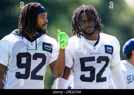 Seattle Seahawks linebacker Boye Mafe, center, works with Aaron Curry,  right, assistant defensive line and defensive ends coach, as linebackers  Tyreke Smith, left, and Joshua Onujiogu, second from left, during NFL  football