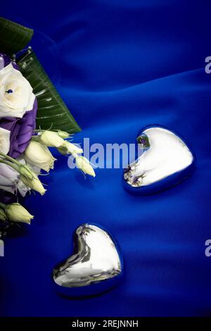 Hearts to put wedding rings next to some flowers Stock Photo