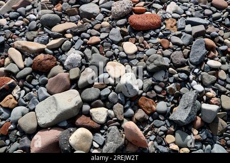 Closeup view of pebbles and stones on a coastal pebble beach Stock Photo