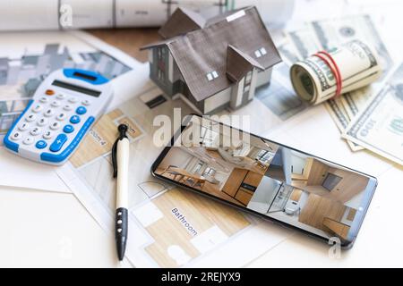 Blueprints, house model, notebook and pen on the table - architecture and real estate concepts Stock Photo