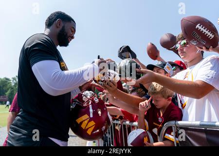 Washington Commanders quarterback Jacoby Brissett signs fan