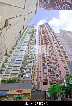 Shot from a typical hong Kong canyon towards the sky with a depiction of the narrowness between the high buildings people taken in 2013 Stock Photo